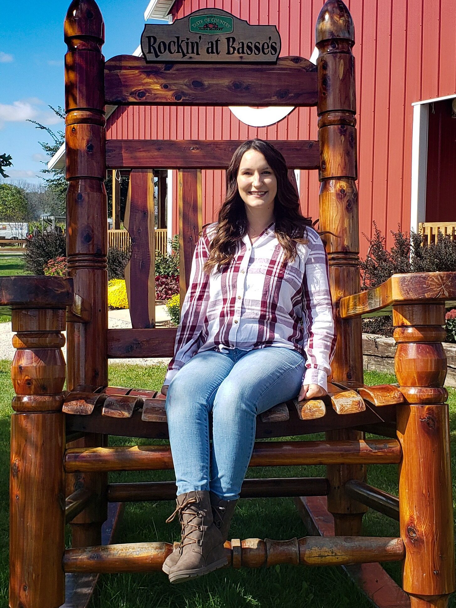 Amber sitting on a large rocking chair at a farm